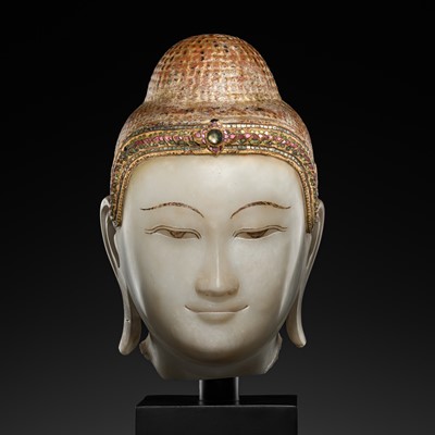 Lot 20 - A GILT-LACQUERED AND GLASS INLAID WHITE ALABASTER HEAD OF BUDDHA, MANDALAY, 18TH-19TH CENTURY