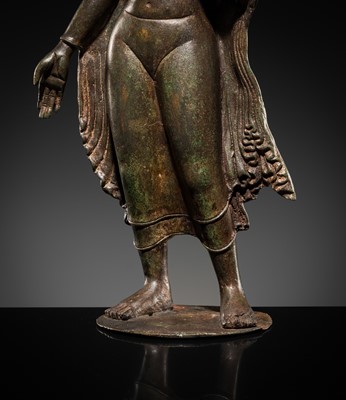 Lot 66 - A LARGE SILVER-INLAID BRONZE FIGURE OF THE CROWNED BUDDHA, KASHMIR, 9TH-10TH CENTURY