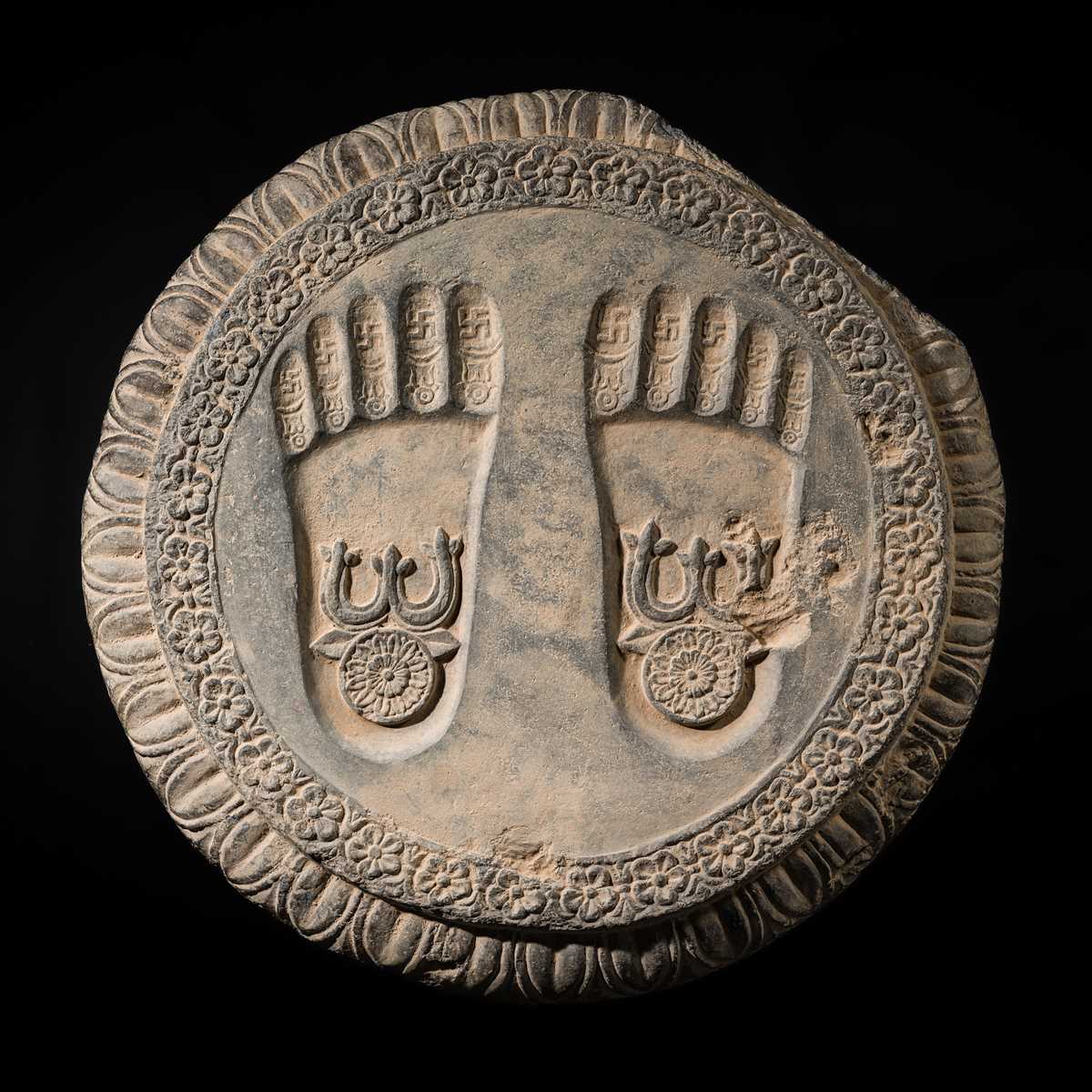 Lot 60 - A SCHIST RELIEF OF THE FOOTPRINTS OF BUDDHA, BUDDHAPADA, 4TH-5TH CENTURY OR EARLIER