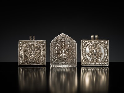 Lot 201 - A GROUP OF TWO SILVER REPOUSSÉ AMULET PENDANTS AND A PILGRIMAGE PLAQUE, 19TH-EARLY 20TH CENTURY