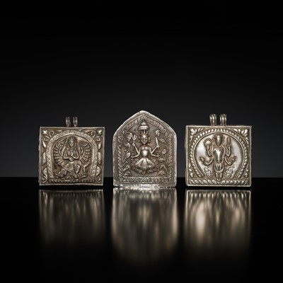 Lot 201 - A GROUP OF TWO SILVER REPOUSSÉ AMULET PENDANTS AND A PILGRIMAGE PLAQUE, 19TH-EARLY 20TH CENTURY