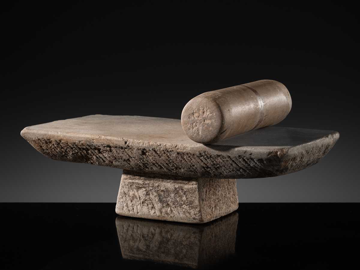 Lot 7 - A SANDSTONE PESANI (GRINDING STONE) AND GRINDER, ANGKOR PERIOD