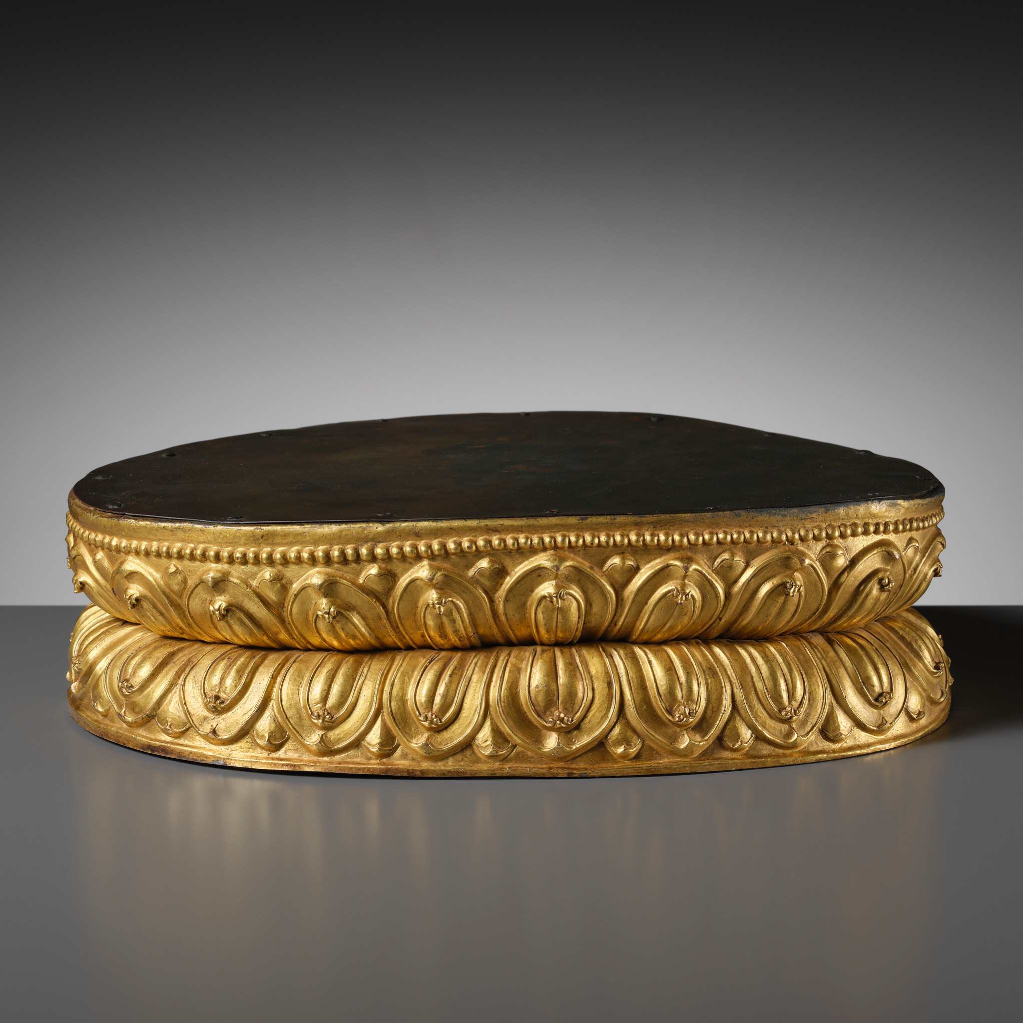 Lot 70 - A LARGE AND GILT COPPER ALLOY BASE, TIBET,
