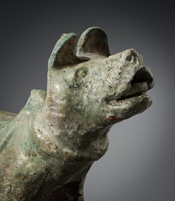 A GREEN-GLAZED POTTERY FIGURE OF A DOG, HAN DYNASTY