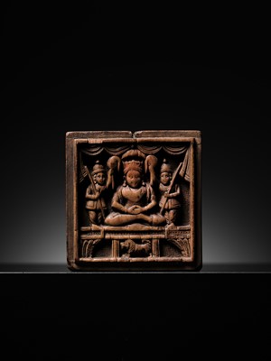 Lot 189 - A SANDALWOOD VOTIVE PLAQUE OF A CROWNED BUDDHA, WEST INDIA, 1ST MILLENNIUM AD