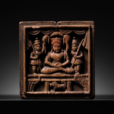 Lot 189 - A SANDALWOOD VOTIVE PLAQUE OF A CROWNED BUDDHA, WEST INDIA, 1ST MILLENNIUM AD