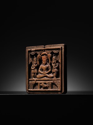 Lot 189 - A SANDALWOOD VOTIVE PLAQUE OF A CROWNED BUDDHA, WEST INDIA, 1ST MILLENNIUM AD