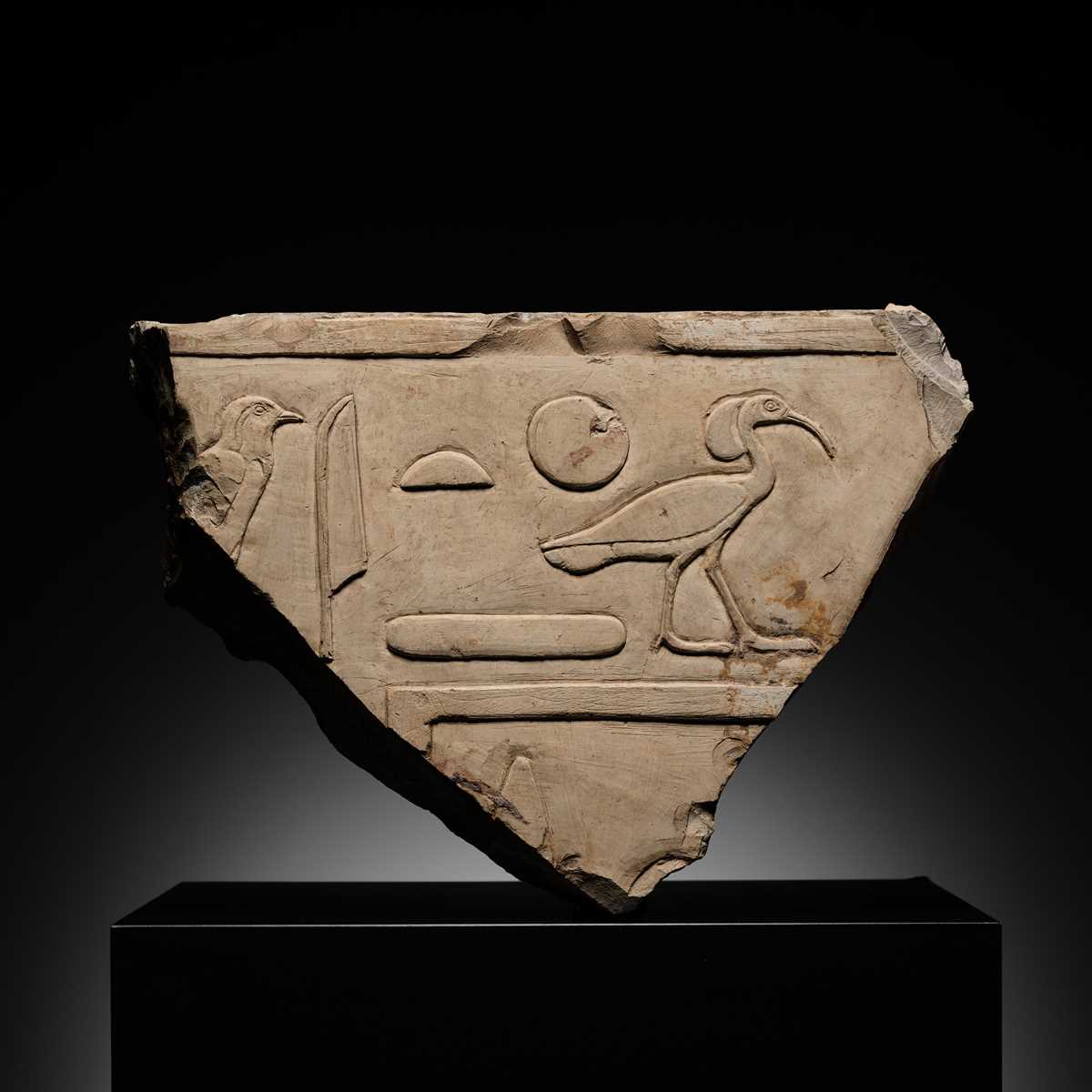 Lot 24 - A WALL RELIEF FRAGMENT DEPICTING AN IBIS, PTOLEMAIC PERIOD