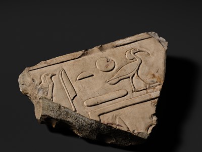 Lot 24 - A WALL RELIEF FRAGMENT DEPICTING AN IBIS, PTOLEMAIC PERIOD