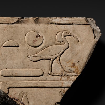 Lot 24 - A WALL RELIEF FRAGMENT DEPICTING AN IBIS, PTOLEMAIC PERIOD