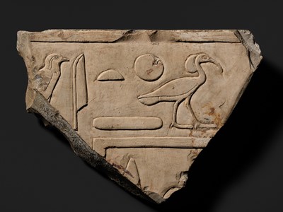 Lot 24 - A WALL RELIEF FRAGMENT DEPICTING AN IBIS, PTOLEMAIC PERIOD