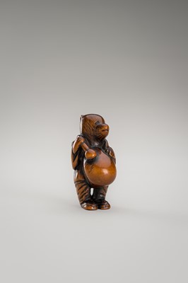 Lot 460 - AN AMUSING WOOD NETSUKE OF A DISGUISED TANUKI