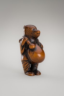 Lot 460 - AN AMUSING WOOD NETSUKE OF A DISGUISED TANUKI