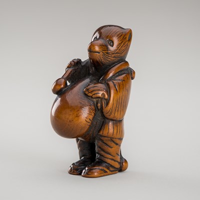 Lot 460 - AN AMUSING WOOD NETSUKE OF A DISGUISED TANUKI