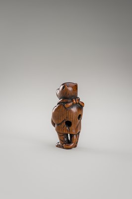 Lot 460 - AN AMUSING WOOD NETSUKE OF A DISGUISED TANUKI