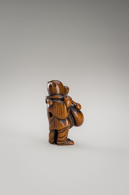 Lot 460 - AN AMUSING WOOD NETSUKE OF A DISGUISED TANUKI