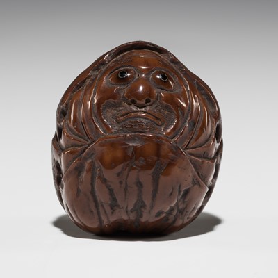 Lot 520 - ISSAN: A FINE KURUMI (WALNUT) NETSUKE DEPICTING DARUMA