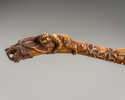 Lot 427 - A LARGE ANTLER SASHI NETSUKE OF A KAPPA AND WASP ON A GOURD