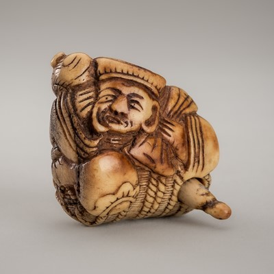 Lot 1258 - AN AMUSING ANTLER KARAKURI (TRICK) NETSUKE OF DAIKOKU WITH A RAT