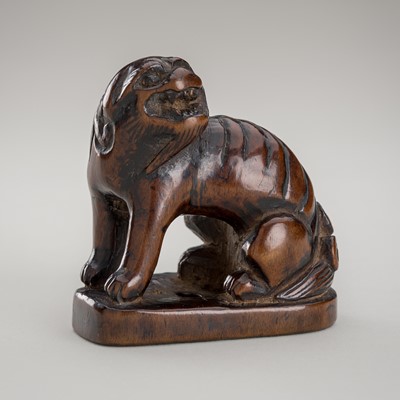 A LARGE WOOD NETSUKE OF A SHISHI