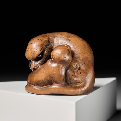 Lot 224 - TOMOHISA: A POWERFUL WOOD NETSUKE OF A TIGER WITH CUB