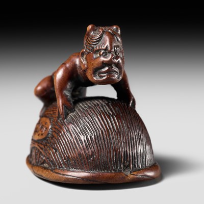 Lot 478 - HOKEI: A WOOD NETSUKE OF AN ONI TRAPPING SHOKI