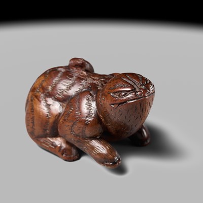 Lot 76 - AN UNUSUAL WOOD NETSUKE OF A CROUCHING TIGER