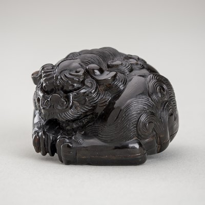 Lot 1286 - A PRESSED HORN NETSUKE OF A SHISHI