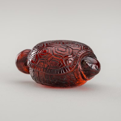 A RARE AMBER NETSUKE OF A MINOGAME