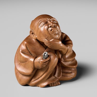 Lot 273 - GYOKKEI: AN AMUSING INLAID WOOD NETSUKE OF A MAN PLUCKING HIS BEARD