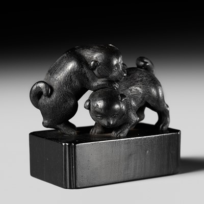 Lot 515 - AN EBONY WOOD NETSUKE OF TWO PUPPIES AT PLAY