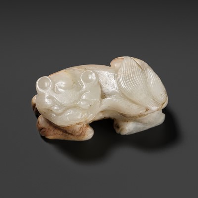 Lot 162 - A WHITE AND RUSSET JADE ‘BUDDHIST LION’ PENDANT, 17TH CENTURY