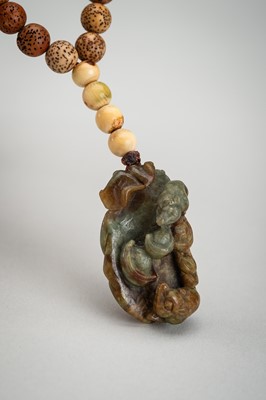 Lot 1786 - A BODHI SEED AND JADE PENDANT NECKLACE