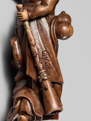 Lot 201 - BAISEN: A RARE WOOD NETSUKE GROUP OF TWO FOREIGN EGG TESTERS