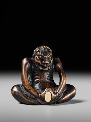 Lot 425 - A RARE WOOD NETSUKE OF AN ONI PARODYING AN EGG TESTER