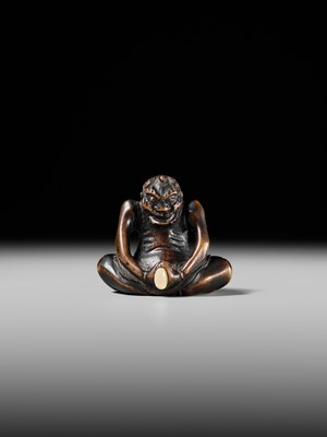 Lot 425 - A RARE WOOD NETSUKE OF AN ONI PARODYING AN EGG TESTER