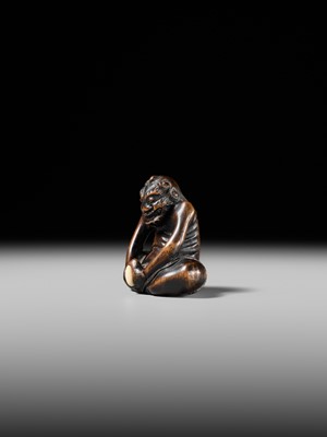 Lot 425 - A RARE WOOD NETSUKE OF AN ONI PARODYING AN EGG TESTER
