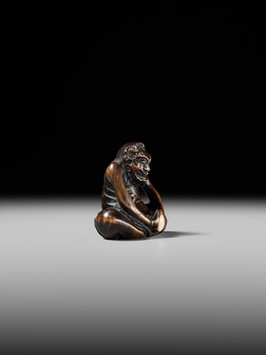 Lot 425 - A RARE WOOD NETSUKE OF AN ONI PARODYING AN EGG TESTER