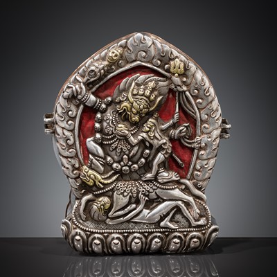 Lot 306 - A PARCEL-GILT SILVER REPOUSSÉ GAU DEPICTING VAJRABHAIRAVA, BHUTAN, 18TH-19TH CENTURY