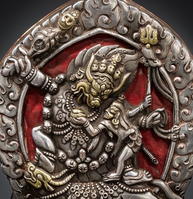 Lot 306 - A PARCEL-GILT SILVER REPOUSSÉ GAU DEPICTING VAJRABHAIRAVA, BHUTAN, 18TH-19TH CENTURY