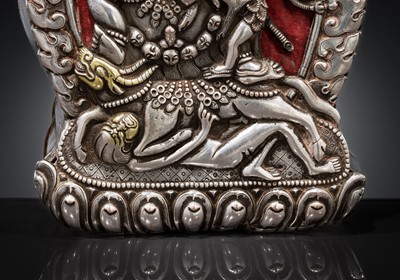 Lot 306 - A PARCEL-GILT SILVER REPOUSSÉ GAU DEPICTING VAJRABHAIRAVA, BHUTAN, 18TH-19TH CENTURY