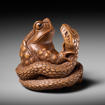 Lot 121 - HARUMITSU: A SUPERB WOOD NETSUKE OF A SNAKE PREYING ON A FROG, SANSUKUMI