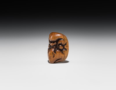 Lot 546 - A WOOD ‘DOUBLE MASK’ NETSUKE OF KARASU TENGU TYPE