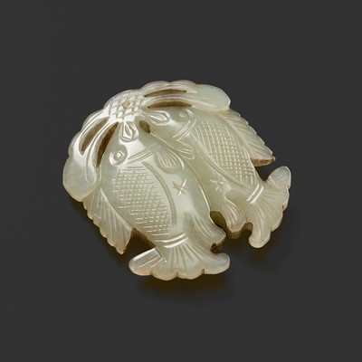 Lot 452 - A CELADON JADE ‘TWIN FISH’ PENDANT