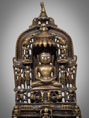 Lot 627 - A JAIN COPPER- AND SILVER-INLAID BRASS SHRINE TO PARSHVANATHA, DATED 1488