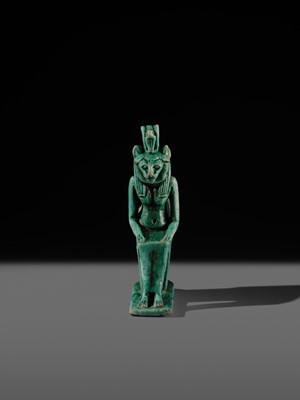 A TURQUOISE-GLAZED FAIENCE AMULET OF THE ENTHRONED SEKHMET, LATE PERIOD, DYNASTY XXVI (SAITE)