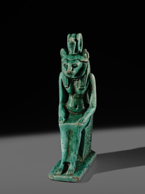 A TURQUOISE-GLAZED FAIENCE AMULET OF THE ENTHRONED SEKHMET, LATE PERIOD, DYNASTY XXVI (SAITE)