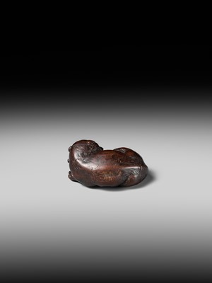 A SUPERB WOOD NETSUKE OF A RECUMBENT TIGER, ATTRIBUTED TO TAMETAKA