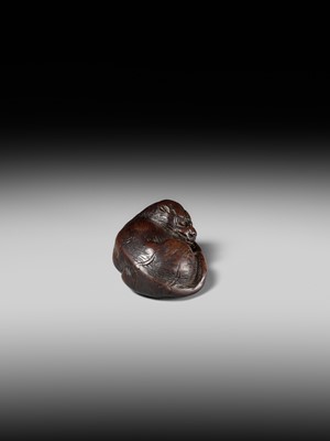 A SUPERB WOOD NETSUKE OF A RECUMBENT TIGER, ATTRIBUTED TO TAMETAKA