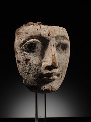 Lot 16 - AN EGYPTIAN GESSO PAINTED WOOD SARCOPHAGUS MASK, LATE PERIOD, 664-332 BC